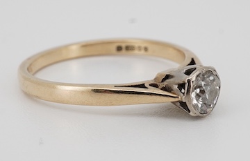 A solitaire diamond ring, collet-set with an antique circular-cut diamond weighing approximately 0.20 carats, mounted in 9ct gold, size L, British hallmarks, gross weight approximately 1.8 grams, Condition: fair